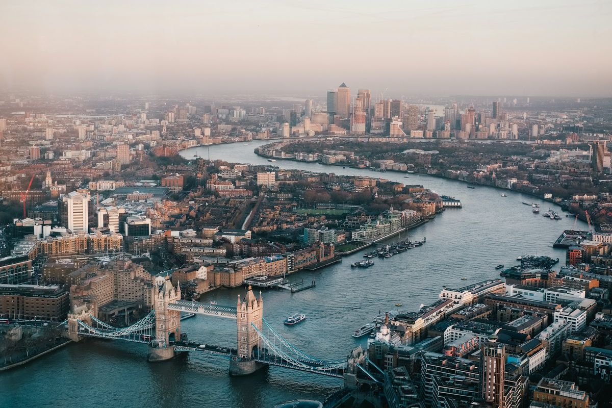 The River Thames winding through London in daylight, with Tower Bridge in the foreground